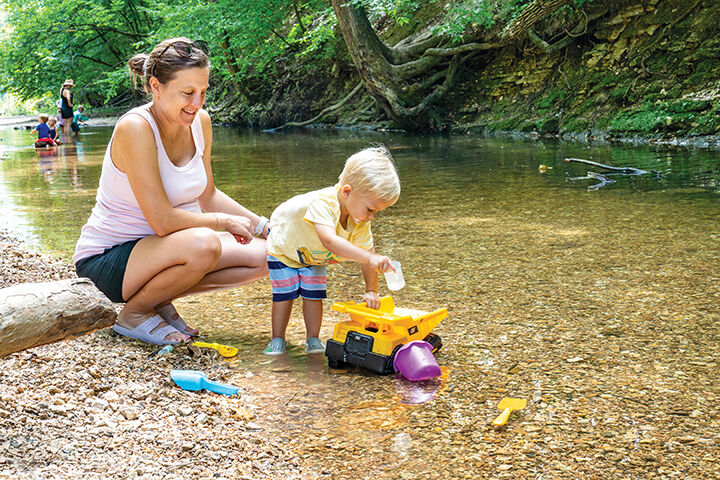 Christina Rankin of St. Louis and her son, Nolan, 2, play in the creek at Mastodon State Historic Site.